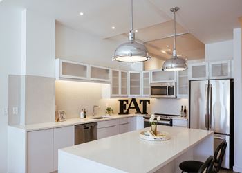 Kitchen with an eat sign on the wall 